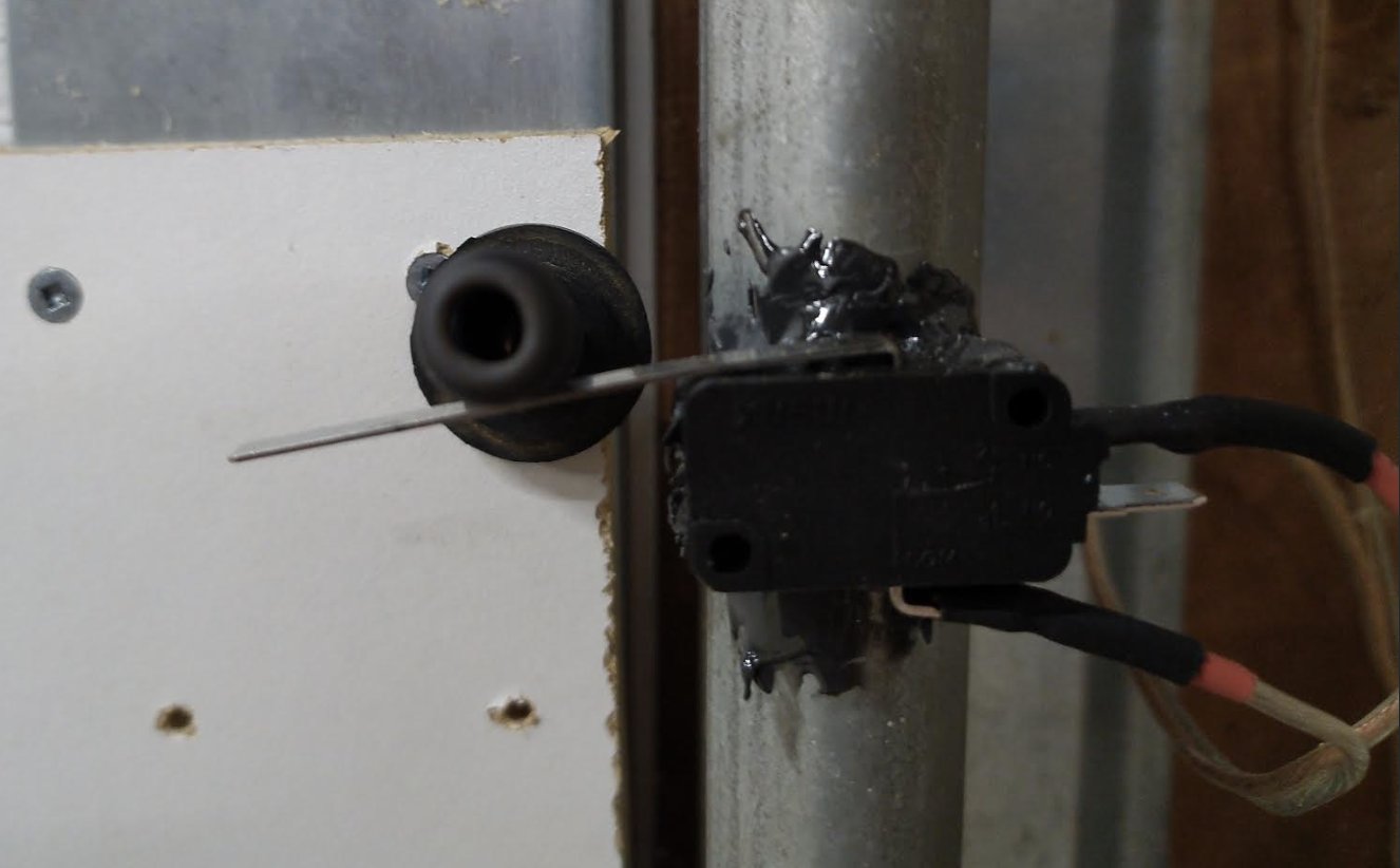 Lever switch epoxied to the track with the spring material pressing the lever